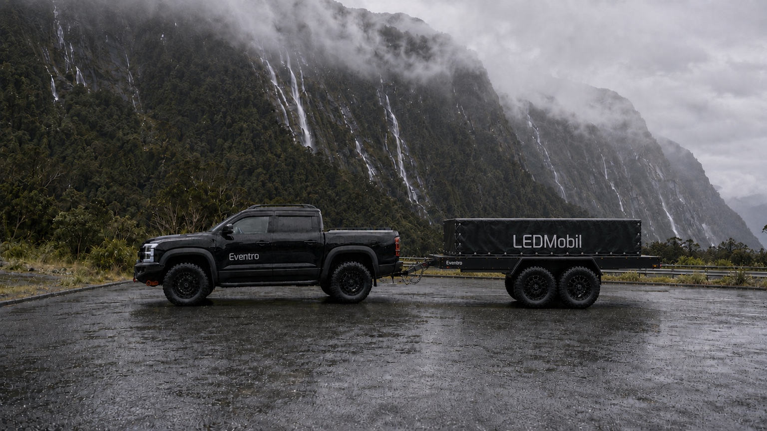 Photorealistic concept render of an Eventro LEDMobil outdoor package beside a mountain landscape